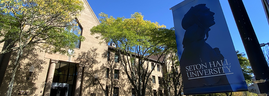 Elizabeth Ann Seton banner hanging on a pole outside of Lewis Hall at Seton Hall University.