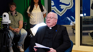 SHU TV students interview Monsignor Reilly.
