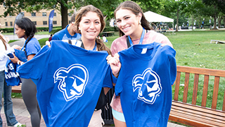 Two students holding Pirate logo tshirts Two students holding Pirate logo tshirts